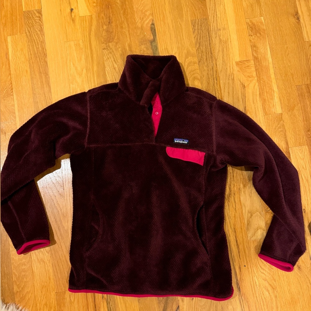 Burgundy Patagonia fleece pullover jacket.